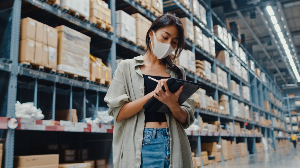 Woman using wms to optimize order fulfillment.